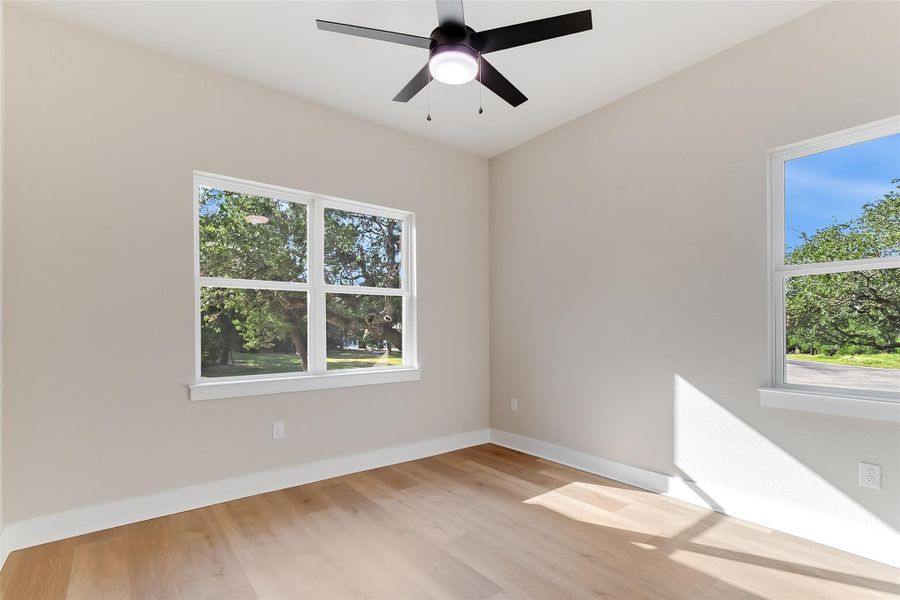 Unfurnished room with light wood-style floors and ceiling fan Unfurnished room with light wood-style floors and ceiling fan