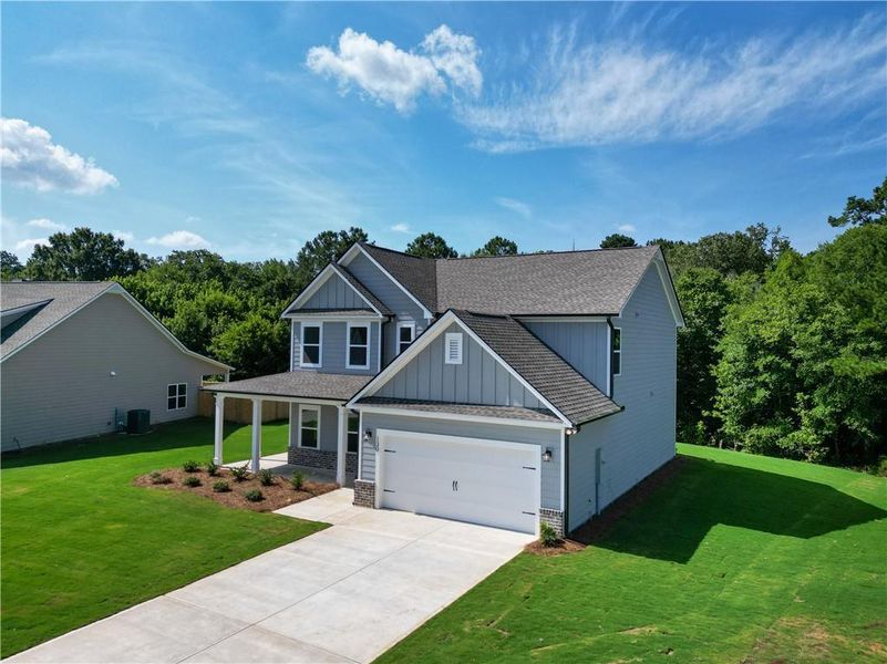 Front exterior of a new home in Harmony Farms, Eatonton, GA, highlighting curb appeal (Image 1). Front exterior of a new home in Harmony Farms, Eatonton, GA, highlighting curb appeal (Image 1).