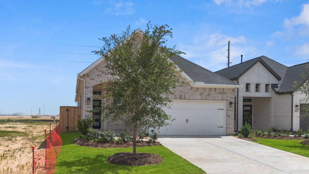 Front exterior of a new home in Jordan Ranch, Fulshear, TX, highlighting curb appeal (Image 23). Front exterior of a new home in Jordan Ranch, Fulshear, TX, highlighting curb appeal (Image 23).