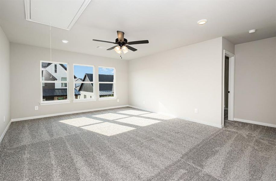 Spare room featuring attic access, light carpet, recessed lighting, and ceiling fan
