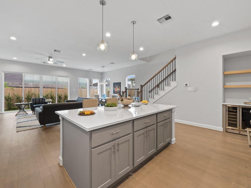The chef-inspired kitchen featuring sleek finishes, smart storage, and a seamless flow into the main living areas. Image depicts home as-is.