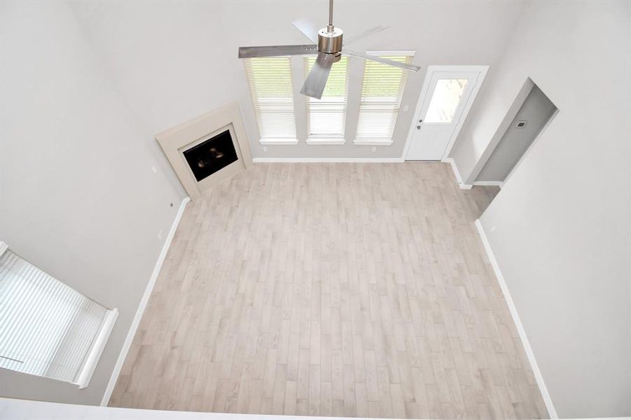 View of family room from landing above. Sample photo of completed home with similar floor plan. Actual colors and selections may vary.