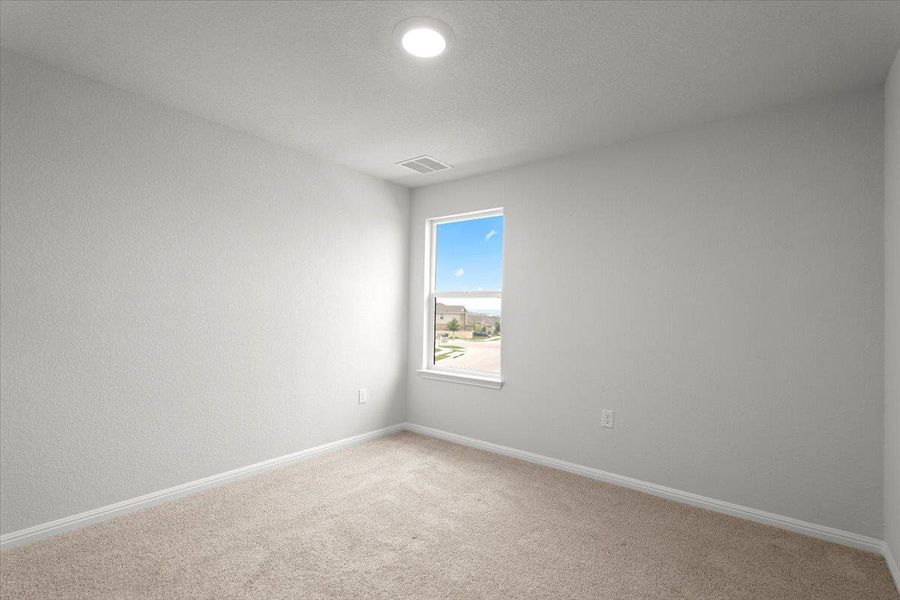 Carpeted room featuring a single window, white baseboards, and a recessed ceiling light