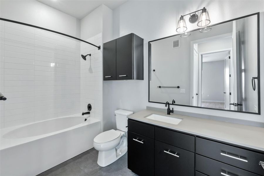 Full bathroom featuring vanity, shower / washtub combination, and tile patterned flooring