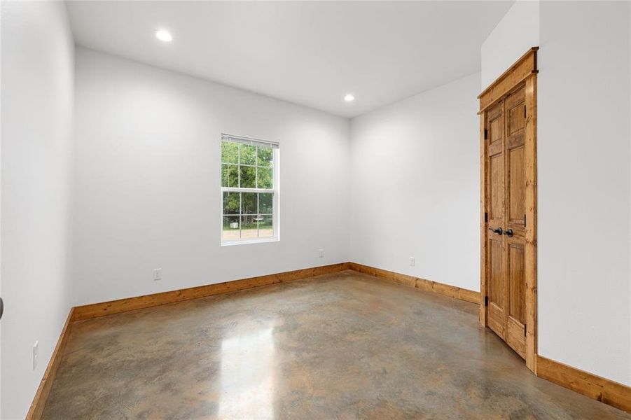 Spare room with concrete flooring, baseboards, and recessed lighting Spare room with concrete flooring, baseboards, and recessed lighting