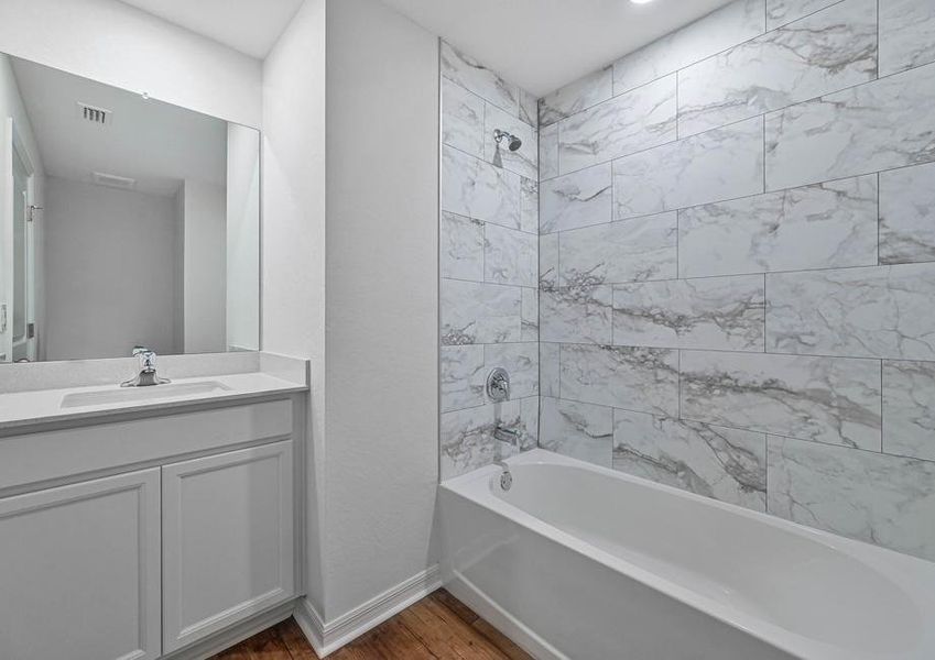 The second bathroom has a spacious vanity and a beautiful tiled bathroom The second bathroom has a spacious vanity and a beautiful tiled bathroom