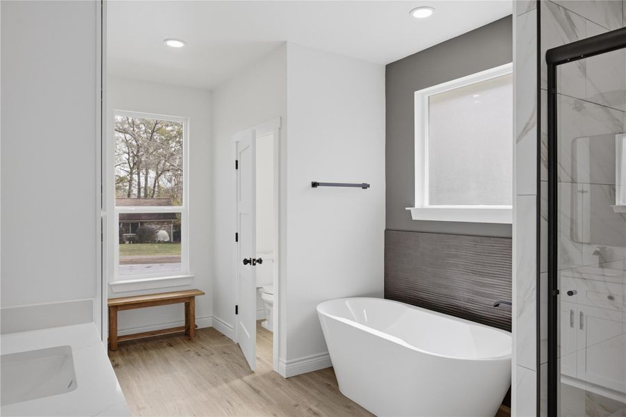 Primary bath retreat highlighted by an elegant soaking tub.