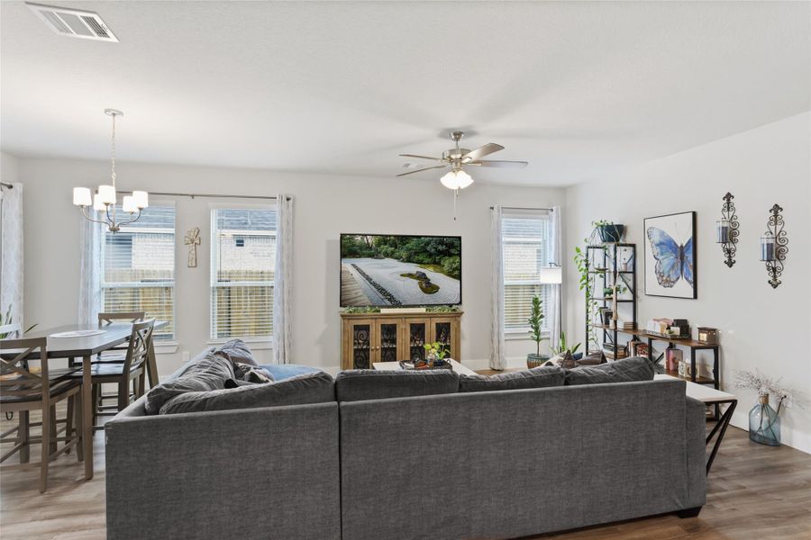 Experience comfort and style in this bright living room featuring elegant decor, a cozy sectional, and ample natural light. Perfect for relaxation and entertaining. Experience comfort and style in this bright living room featuring elegant decor, a cozy sectional, and ample natural light. Perfect for relaxation and entertaining.