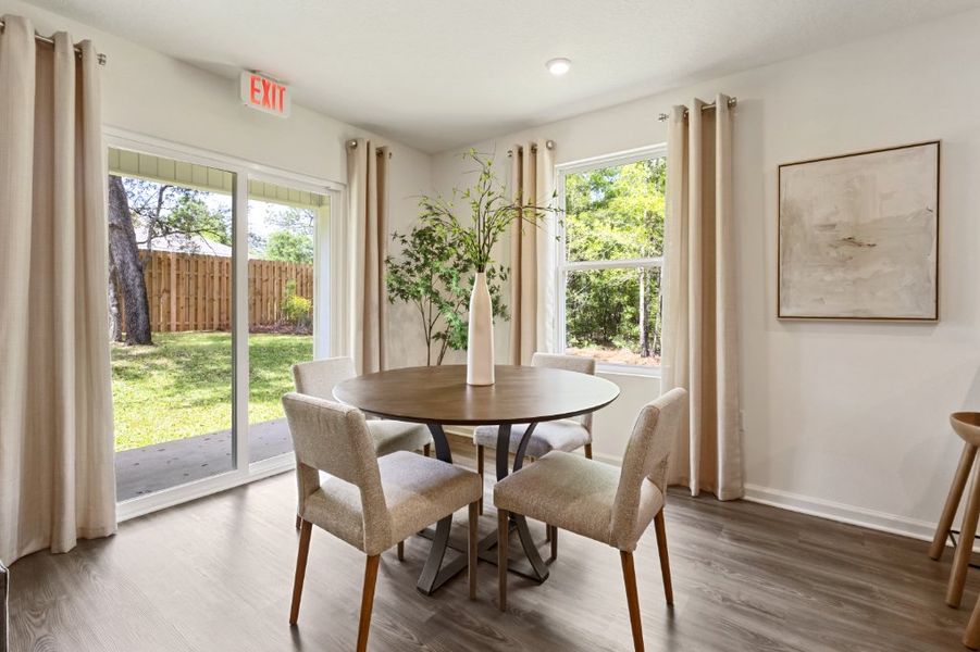 A dining room with a table and chairs. A dining room with a table and chairs.