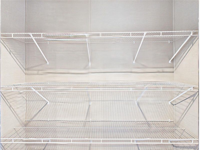 Walk-In Closet – Generous walk-in closet with multiple shelving tiers, providing excellent storage and organization options.