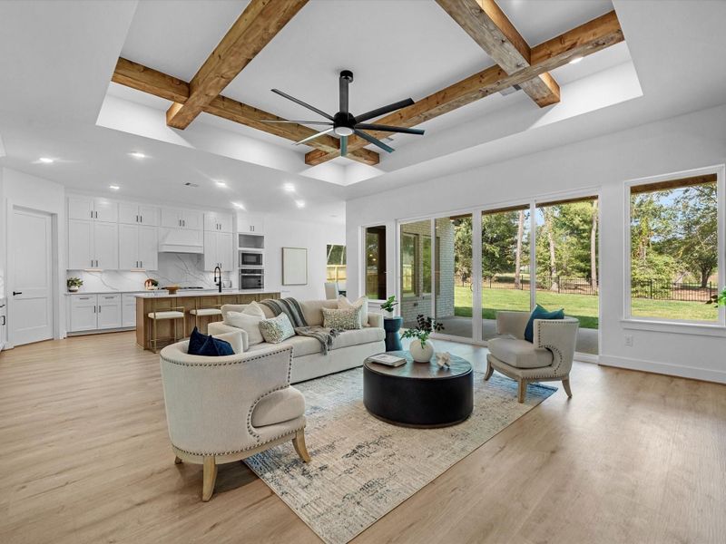 This thoughtfully designed open concept is highlighted by the natural lighting and and table top ceiling, adorned with crossing timber beams