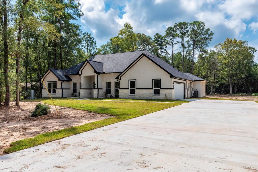 Front exterior of a new home in , Dayton, TX, highlighting curb appeal (Image 22).