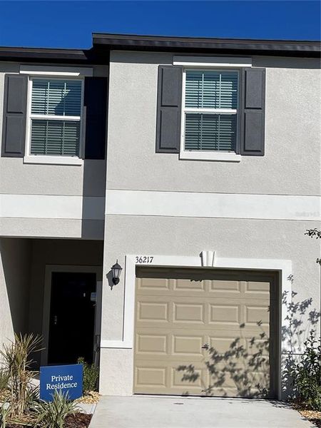 Front exterior of a new home in , Zephyrhills, FL, highlighting curb appeal (Image 1). Front exterior of a new home in , Zephyrhills, FL, highlighting curb appeal (Image 1).