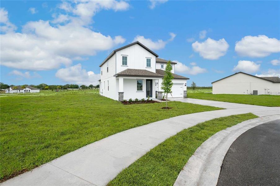 Front exterior of a new home in Citrus Place, Babson Park, FL, highlighting curb appeal (Image 17).