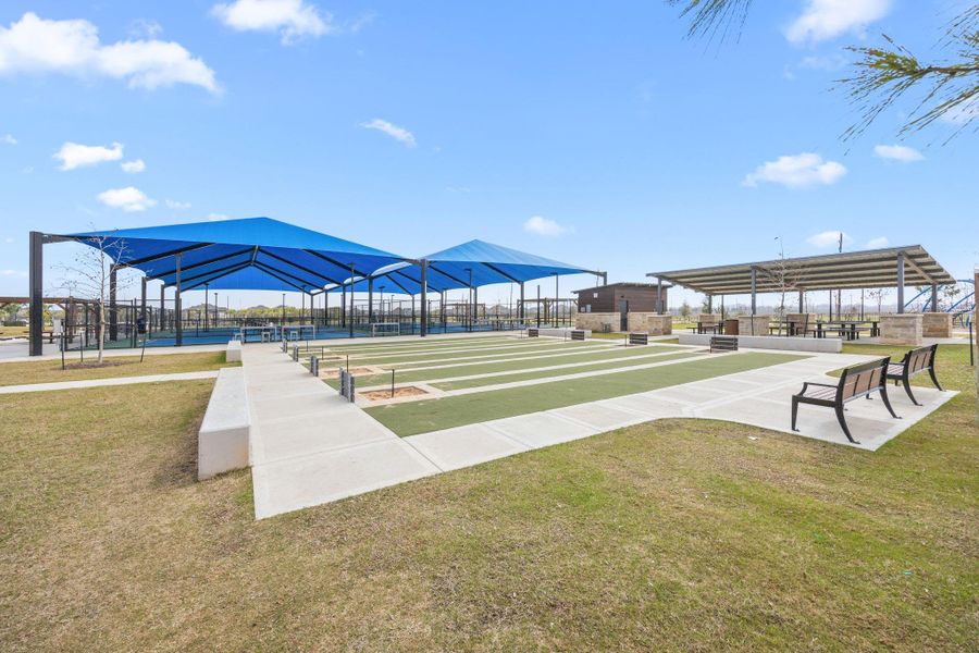 Shaded pavilion areas, lawn game courts, and open seating provide additional outdoor entertainment options.