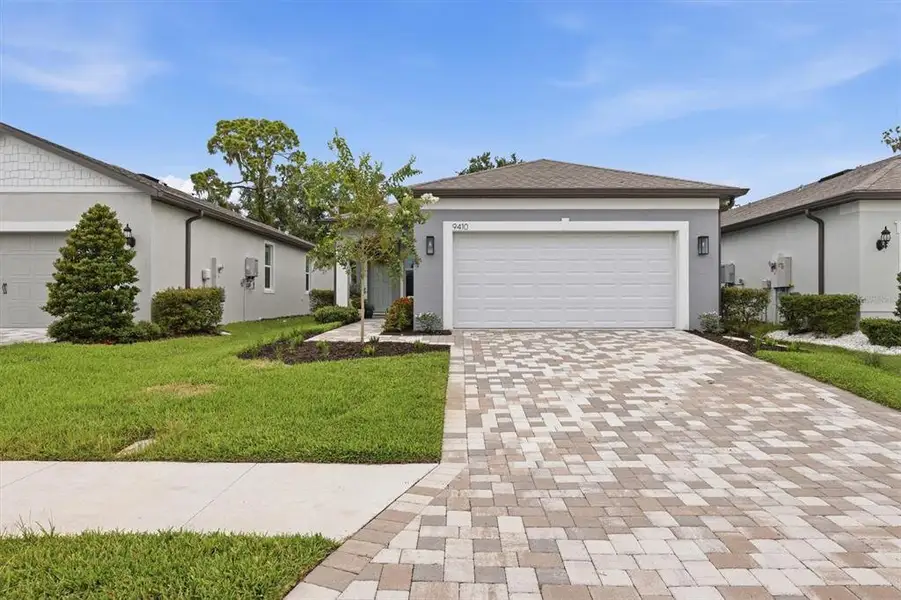 Front exterior of a new home in Del Webb BayView, Parrish, FL, highlighting curb appeal (Image 2). Front exterior of a new home in Del Webb BayView, Parrish, FL, highlighting curb appeal (Image 2).