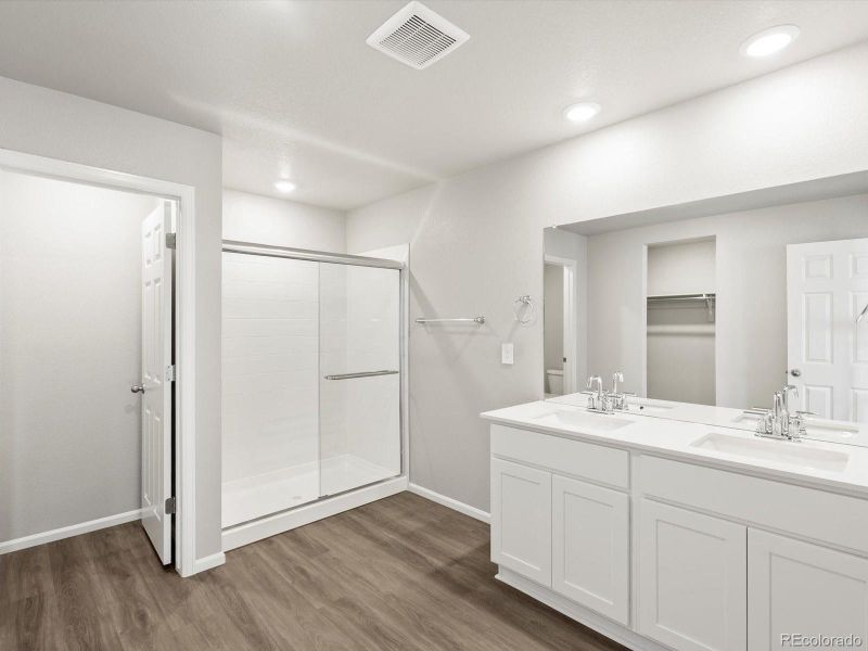 Master Bathroom with walk in shower, quartz counters and double vanity