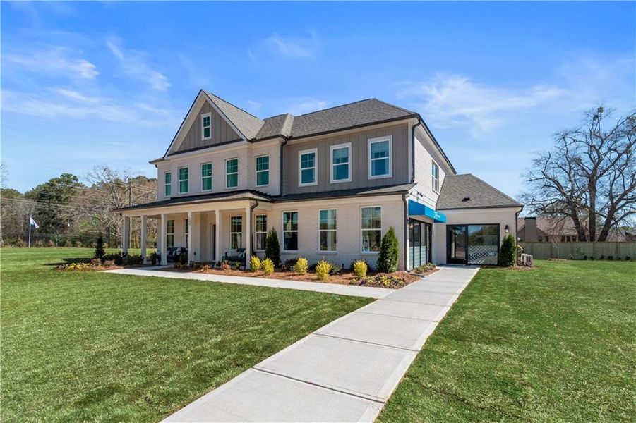 Front exterior of a new home in Cambria at Traditions, Hampton, GA, highlighting curb appeal (Image 2). Front exterior of a new home in Cambria at Traditions, Hampton, GA, highlighting curb appeal (Image 2).