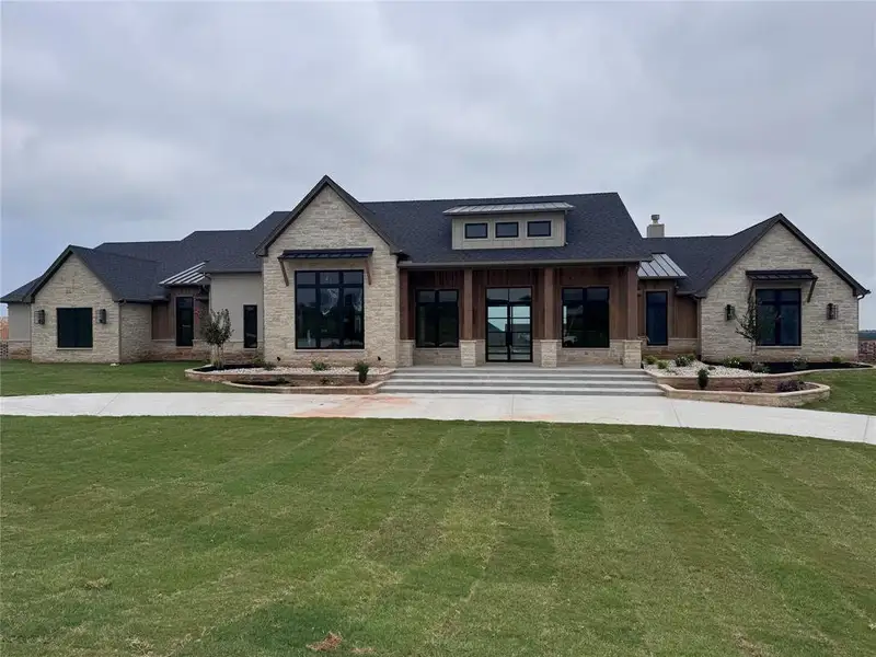 Front exterior of a new home in , Aledo, TX, highlighting curb appeal (Image 1). Front exterior of a new home in , Aledo, TX, highlighting curb appeal (Image 1).