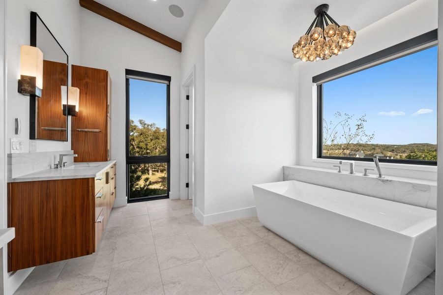 Full bathroom with a chandelier, baseboards, vanity, beam ceiling, and a freestanding bath Full bathroom with a chandelier, baseboards, vanity, beam ceiling, and a freestanding bath