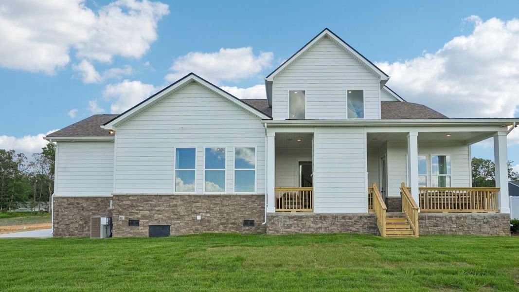Rear exterior of home with view of spacious rear covered patio Rear exterior of home with view of spacious rear covered patio
