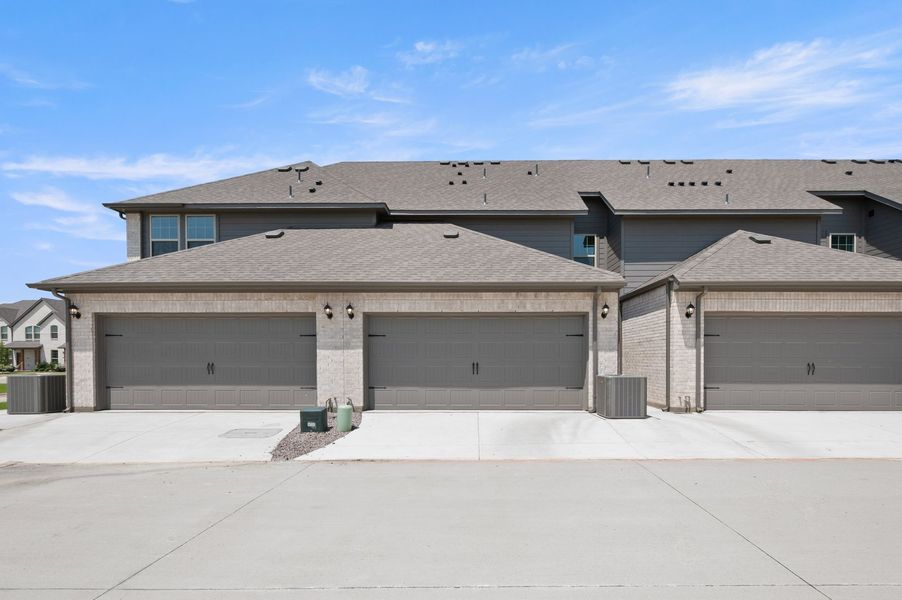 Front exterior of a new home in Sanger Circle – Townhomes, Sanger, TX, highlighting curb appeal (Image 27). Front exterior of a new home in Sanger Circle – Townhomes, Sanger, TX, highlighting curb appeal (Image 27).