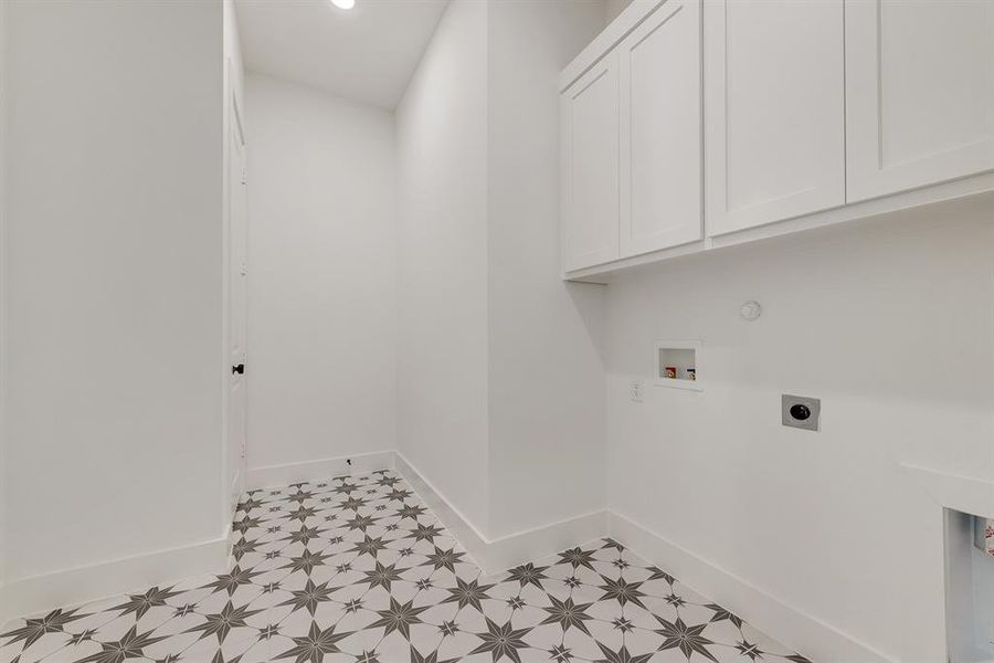 Washroom featuring hookup for an electric dryer, hookup for a washing machine, light floors, and cabinet space Washroom featuring hookup for an electric dryer, hookup for a washing machine, light floors, and cabinet space