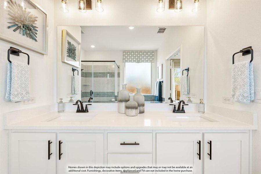 Bathroom with double vanity, white cabinets, large mirror, and glass walk-in shower visible in background Bathroom with double vanity, white cabinets, large mirror, and glass walk-in shower visible in background
