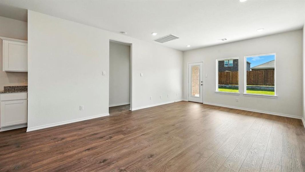 Spacious common area featuring wood-finish flooring, recessed lighting, and light gray wall paint