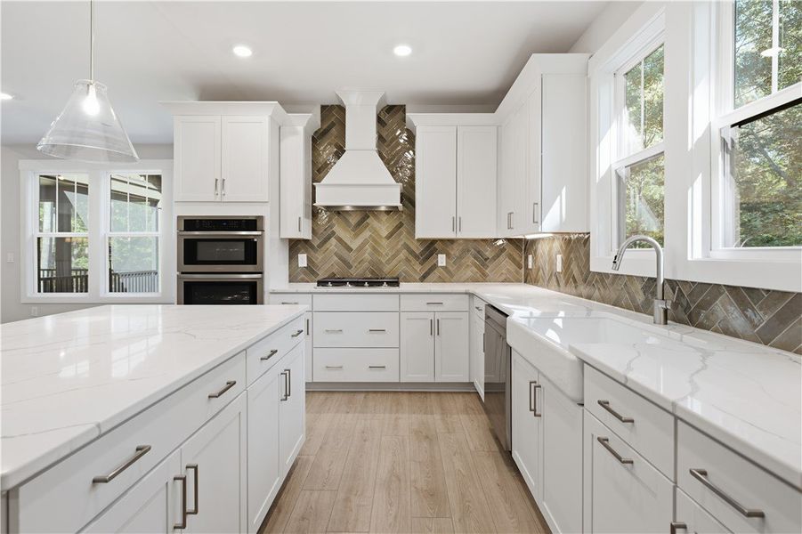 Gleaming stone countertops and a custom tiled back