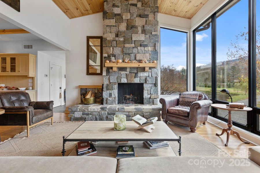 Floor to Ceiling Fireplace and Wall to Wall Windows makes this Space Shine