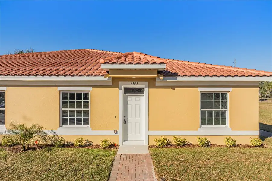 Front exterior of a new home in , Kissimmee, FL, highlighting curb appeal (Image 2). Front exterior of a new home in , Kissimmee, FL, highlighting curb appeal (Image 2).