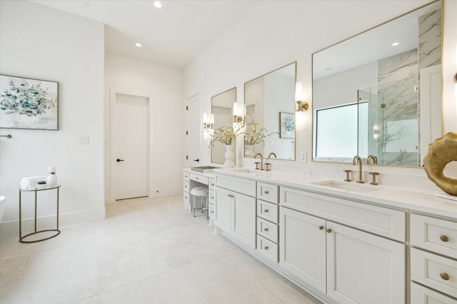 Primary bath - features quartz counter top, double-sink and vanity, designer sconce lighting and porcelain flooring.