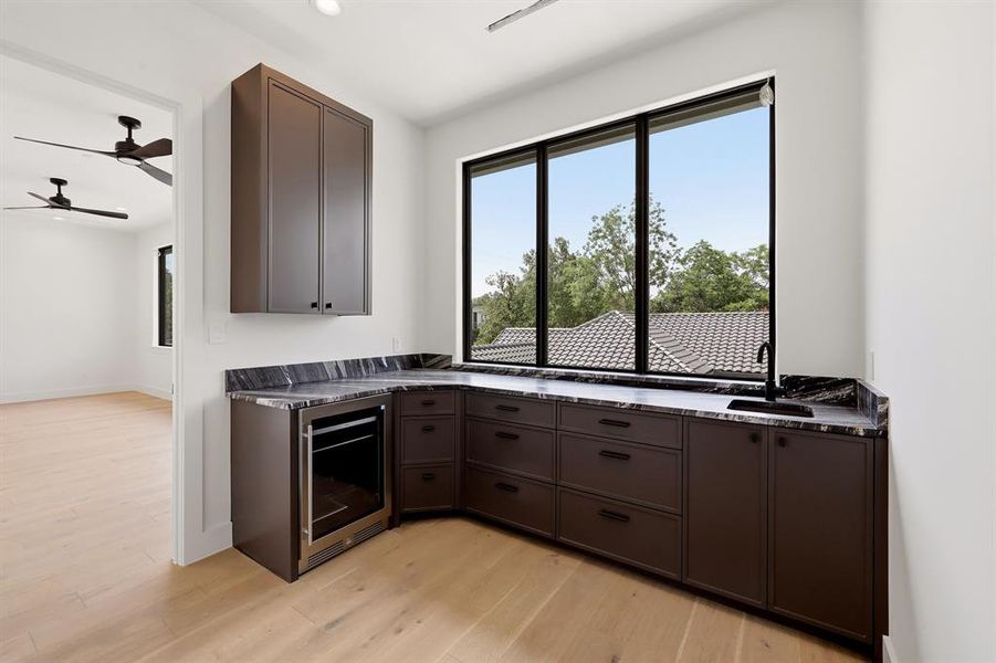 second floor features a convenient concession area with a sink and beverage refrigerator, perfectly positioned to serve the media room and gym.