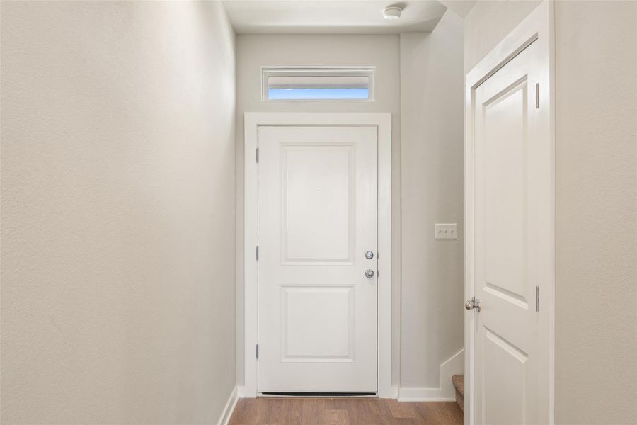 Entryway featuring wood finished floors and baseboards Entryway featuring wood finished floors and baseboards