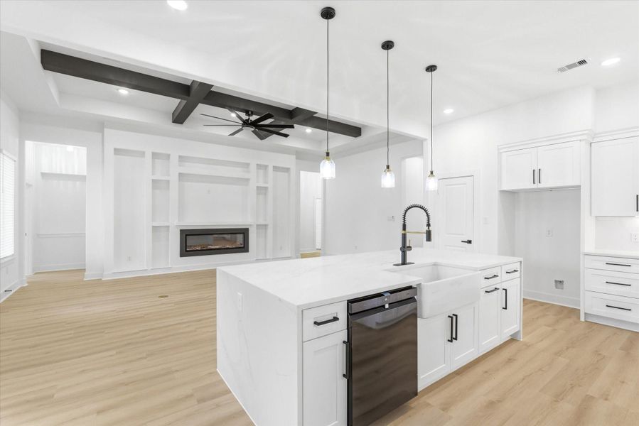 Excellent sightlines connect the living and kitchen areas, thanks to this thoughtfully designed open-concept layout. The impressive ceiling beam detail in the great room is truly one of a kind!
