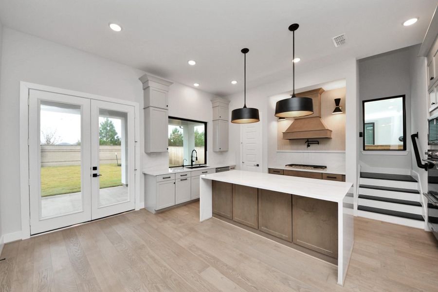 These second set of stairs lead upstairs to an oversized gameroom.