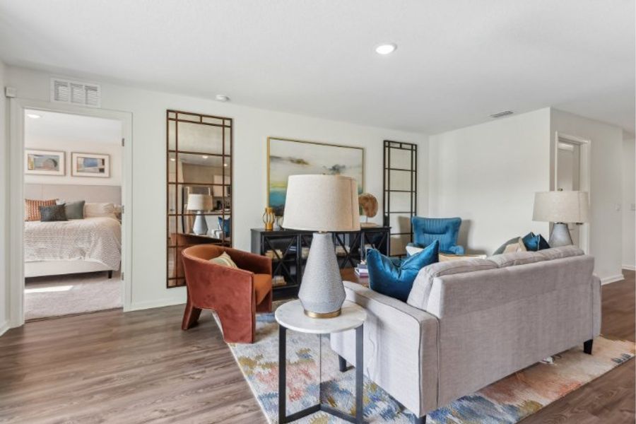 A living room with a bed and a lamp. A living room with a bed and a lamp.