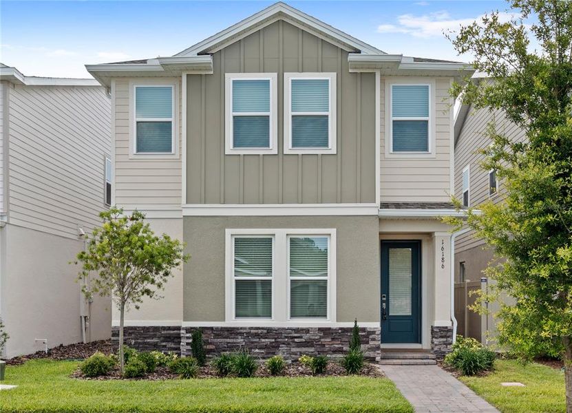 Front exterior of a new home in Harvest at Ovation, Winter Garden, FL, highlighting curb appeal (Image 25).