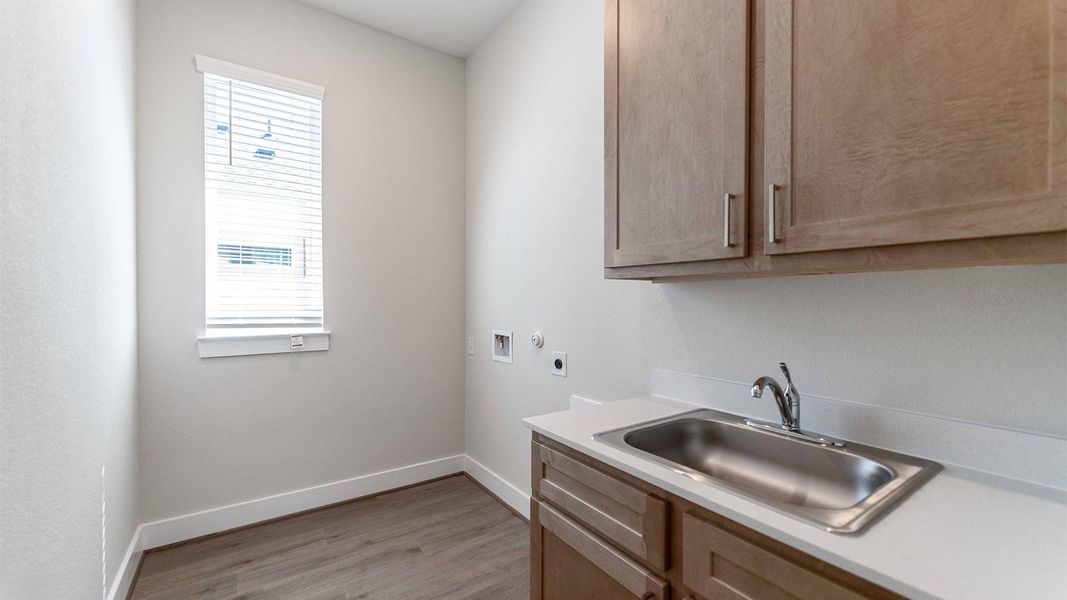 Laundry room featuring cabinet space, hookup for a washing machine, light wood-type flooring, and hookup for an electric dryer Laundry room featuring cabinet space, hookup for a washing machine, light wood-type flooring, and hookup for an electric dryer