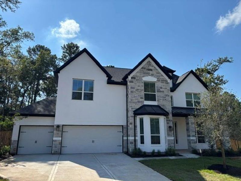 Front exterior of a new home in The Woodlands Hills, Willis, TX, highlighting curb appeal (Image 23).