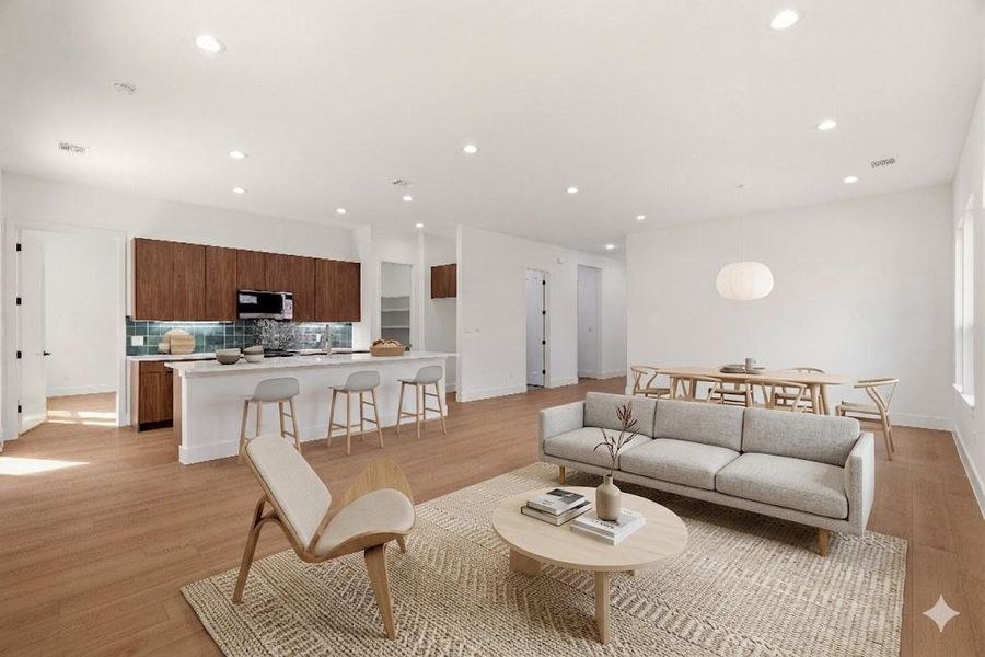 Living area with light wood-style floors and recessed lighting