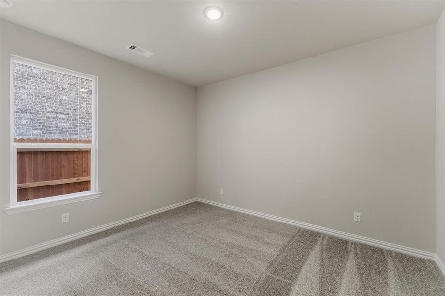 Unfurnished room with light colored carpet and baseboards