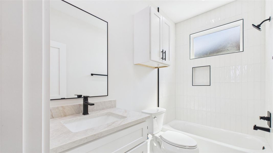 This bathroom features a modern design with a white color scheme. .