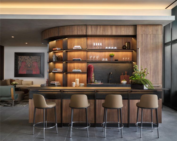 Sleek wood paneling and stone counters define this modern integrated wet bar area. Sleek wood paneling and stone counters define this modern integrated wet bar area.