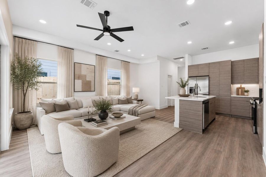 Open-concept living designed for connection, featuring elevated ceilings, abundant natural light, and seamless flow into the kitchen and dining spaces.