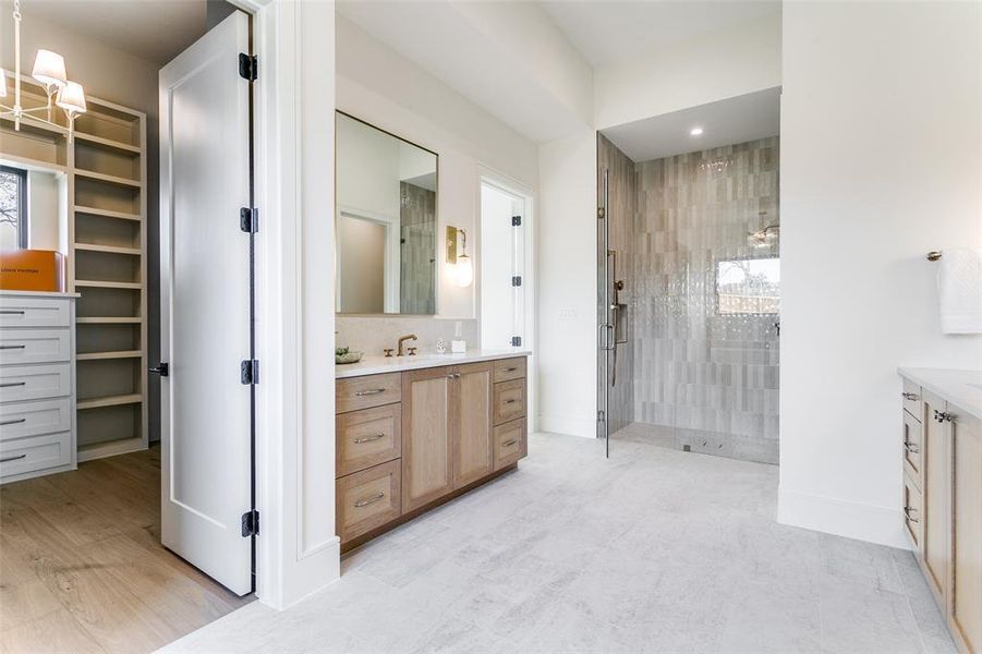 Views into the beautiful shower in the primary bath and into one of the two spacious closets in the primary suite. Second closet offers full sized stackable washer and dryer connections. Views into the beautiful shower in the primary bath and into one of the two spacious closets in the primary suite. Second closet offers full sized stackable washer and dryer connections.