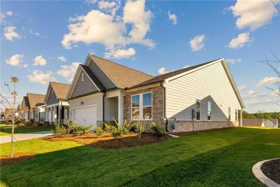Front exterior of a new home in Kelly Preserve, Loganville, GA, highlighting curb appeal (Image 2). Front exterior of a new home in Kelly Preserve, Loganville, GA, highlighting curb appeal (Image 2).