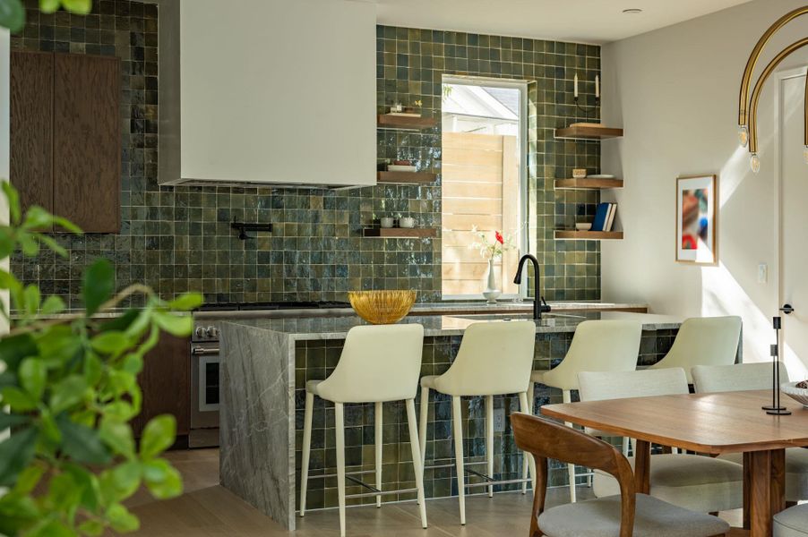 Gleaming stone countertops and textured tile walls create a sophisticated focal point in this kitchen. Gleaming stone countertops and textured tile walls create a sophisticated focal point in this kitchen.