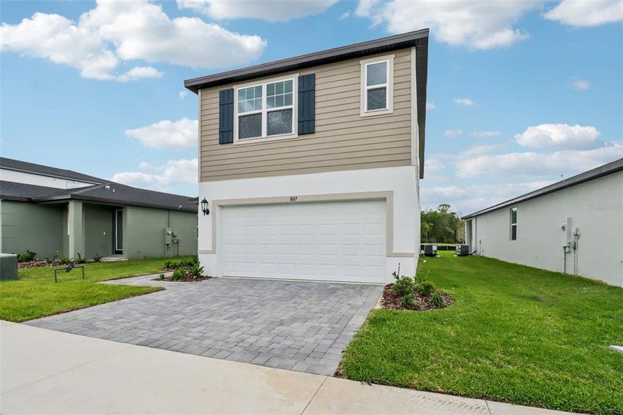 Front exterior of a new home in The Reserve at Hammock Oaks - Classic Series, Lady Lake, FL, highlighting curb appeal (Image 1). Front exterior of a new home in The Reserve at Hammock Oaks - Classic Series, Lady Lake, FL, highlighting curb appeal (Image 1).
